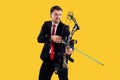 Businessman aiming at target with bow and arrow, isolated on yellow background Royalty Free Stock Photo