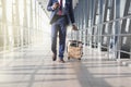 Businessman at airport moving to terminal gate for business trip, front view