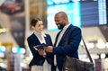 Businessman, airport and passenger assistant helping traveler in departure, flight time or passport information. Black Royalty Free Stock Photo