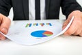 Businessman analysing a set of bar and pie graphs Royalty Free Stock Photo