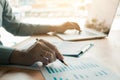 Businessman analyzing annual business report and holding pen and Royalty Free Stock Photo