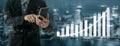 Businessman Analyzing Data on Smartphone with Financial Graphs in Background for Modern Technology Concept Impute Royalty Free Stock Photo
