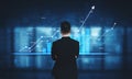 Businessman Analyzing Financial Growth Trends on Digital Display with Graphs and Charts Representing Data Metrics and Royalty Free Stock Photo