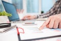 Businessman analyzing graphs and diagrams on wooden table Royalty Free Stock Photo