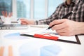 Businessman analyzing graphs and diagrams on wooden table Royalty Free Stock Photo