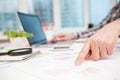 Businessman analyzing graphs and diagrams on wooden table Royalty Free Stock Photo