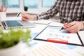 Businessman analyzing graphs and diagrams on wooden table Royalty Free Stock Photo