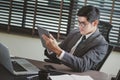 Businessman analyzing investment charts with tablet and laptop. Royalty Free Stock Photo