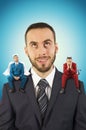 Businessman with angel and devil on his shoulders. Royalty Free Stock Photo