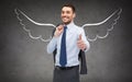 Businessman with angel wings showing thumbs up Royalty Free Stock Photo