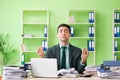 The businessman angry with excessive work sitting in the office Royalty Free Stock Photo