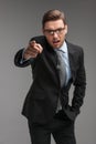 Businessman angry and shouting over isolated grey background. Royalty Free Stock Photo