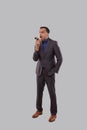 Businessman Angry Talking on Phone Isolated. Indian Businessman Yelling on Phone Standing Full Length Royalty Free Stock Photo