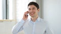 Businessman Answering Phone Call in Office Royalty Free Stock Photo