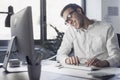 Businessman answering phone calls in the office Royalty Free Stock Photo