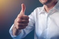 Businessman approving with raised thumb up gesture