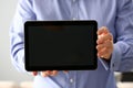 Businessman arm expose blank monitor of pc pad to camera closeup