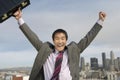 Businessman With Arms Out Against Buildings Royalty Free Stock Photo