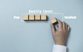Businessman array wooden block cube for increasing quality level from poor to excellent , Continuous quality improvement concept Royalty Free Stock Photo