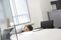 Businessman Asleep At Office Desk