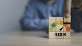 Businessman assemble risk level indicator rating print screen wooden cube block since low to high with copy space for Risk