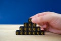 Businessman assembling black dices with gold Ã¢âÂ¬ euro signs in a shape of pyramid in a conceptual image