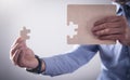 Businessman assembling jigsaw puzzle. Business