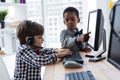 Businessman assisting colleague talking through headset at desk Royalty Free Stock Photo