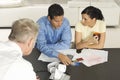 Businessman Assisting Couple with Credit Cards Royalty Free Stock Photo