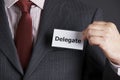 Businessman Attaching Delegate Badge To Jacket