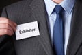 Businessman Attaching Exhibitor Badge To Jacket