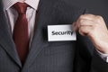 Businessman Attaching Security Badge To Jacket