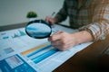 Businessman or Auditor Hand Looking At Tax Fraud Investigation, accounting records, financial statement, Internal audit, Through Royalty Free Stock Photo