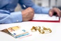 Businessman in the back, euro banknotes and gold jewellry in the front Royalty Free Stock Photo
