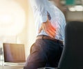 Businessman, back pain and x ray of spine from sitting and working by laptop on desk chair at the office. Employee male Royalty Free Stock Photo