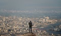 Businessman with backpack standing on summit looking city view with air pollution environment Royalty Free Stock Photo