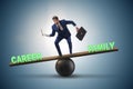 Businessman balancing between career and family in business conc Royalty Free Stock Photo