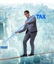 Businessman balancing between debt and tax Royalty Free Stock Photo