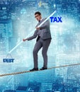 Businessman balancing between debt and tax Royalty Free Stock Photo