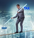 Businessman balancing between debt and tax Royalty Free Stock Photo