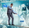 Businessman balancing between debt and tax