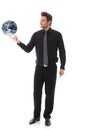 Businessman balancing globe on forefinger