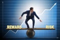 The businessman balancing between reward and risk business concept Royalty Free Stock Photo