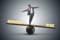 The businessman balancing between reward and risk business concept Royalty Free Stock Photo