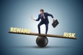 The businessman balancing between reward and risk business concept Royalty Free Stock Photo