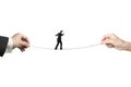 Businessman balancing on tightrope with man and woman hands hold Royalty Free Stock Photo