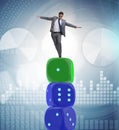 Businessman balancing on top of dice stack in uncertainty concep Royalty Free Stock Photo