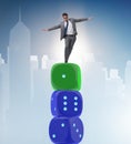 Businessman balancing on top of dice stack in uncertainty concep Royalty Free Stock Photo