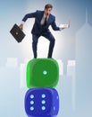 Businessman balancing on top of dice stack in uncertainty concep Royalty Free Stock Photo