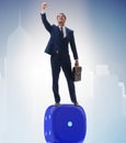 Businessman balancing on top of dice stack in uncertainty concep Royalty Free Stock Photo